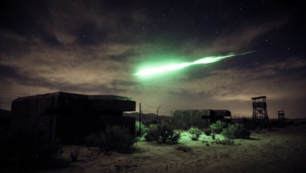 Green fireball over a 1940s desert nuclear installation, evoking the DOE and CIA UAP files released in the PURSUE tranches